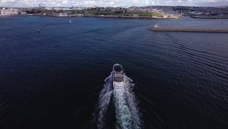 Luxury-Boat-Sailing-into-the-Plymouth-Hoe-in-Devon-with-Scenic-Aerial-Views-from-Above