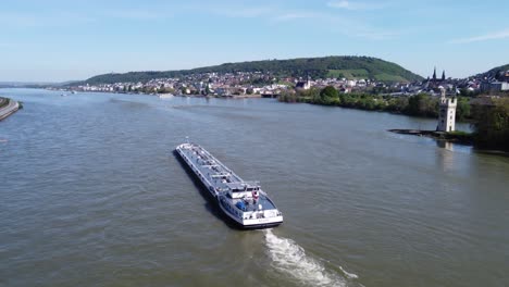 Tanker-barge-navigate-upstream-on-river-Rhine-in-Bingen-Germany,-Aerial