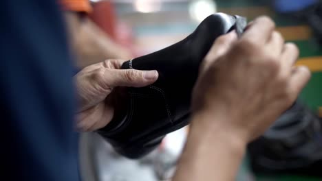 Hand-meticulously-applies-shoe-shiner-to-a-shoe-making-it-shine