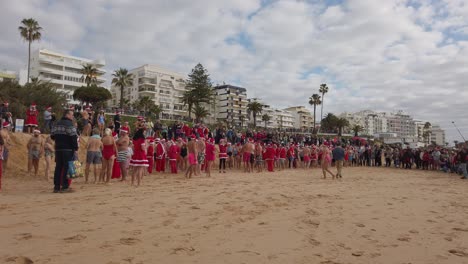 People-dressed-as-Santa-Claus-are-waiting-for-the-start-of-the-traditional-swim-in-the-sea