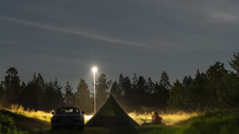 A-family-is-camping-in-the-dim-lit-Norwegian-forest-landscape