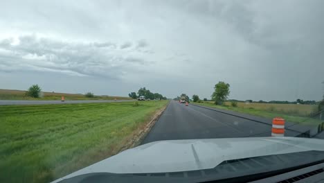 POV--driving-thru-a-construction-zone-on-the-interstate-in-the-Midwest-on-a-cloudy,-rainy-summer-day