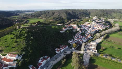 Entrance-to-the-city-of-Aljezur-in-Portugal,-castle-on-top-of-the-hill,-clifftop-landscapes