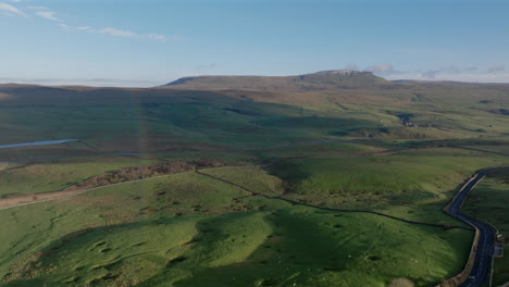 Pullback-Wide-Angle-Drone-Shot-of-Rural-Landscape-and-Pen-y-ghent