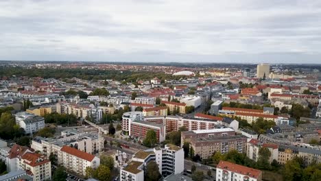 A-rising-drone-shot-of-downtown-Leipzig,-Germany-on-a-cloudy-day