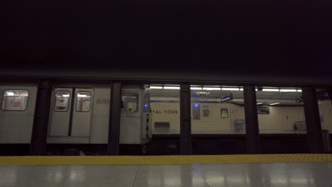 Subway-trains-depart-from-dark-Royal-York-station-in-Toronto,-static