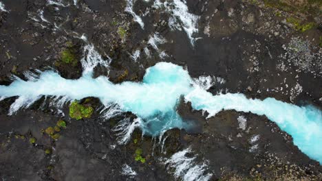 Aerial-view-of-bridge-leading-over-Bruarfoss-Waterfall,-Iceland
