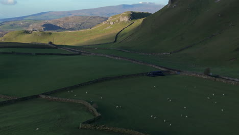 Establishing-Drone-Shot-of-Fields-of-Sheep-in-Yorkshire-Dales-and-Tractor