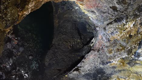 High-angle-shot-of-volcanic-cave-filling-with-water-in-Algar-do-Carvao