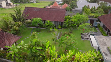 Scenic-Villa-With-Surrounding-Ricefields-In-Canggu,-Bali,-Indonesia---Aerial-Shot