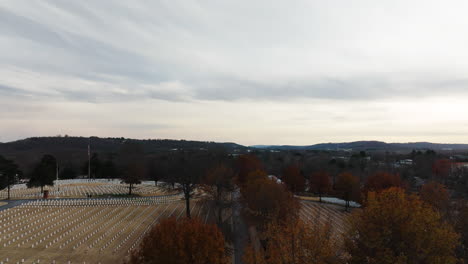 Aerial-drone-rising,-tilt-down-reveals-vast-Cemetery-in-Arkansas-Fayetteville
