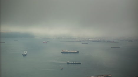 Moody-foggy-day-over-port-of-Gibraltar,-time-lapse-view