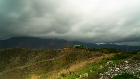 Stormy-clouds-flowing-above-mountains-of-Estepona,-time-lapse-view