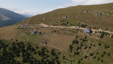 Drone-view-of-the-plateau-built-on-the-hill,-the-settlement-among-the-greenery