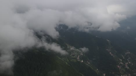 Drone-view-of-mountain-and-rural-settlement-on-an-overcast-and-foggy-day