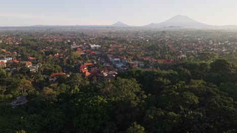 Cinematic-sunrise-view-of-Ubud-town-famous-for-traditional-crafts-with-volcano-Agung-at-the-background-and-Monkey-Forest-at-foreground