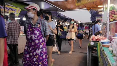 People-In-Face-Mask-Walking-Through-Food-Stalls-At-Star-Fresh-Market-In-Rayong,-Thailand