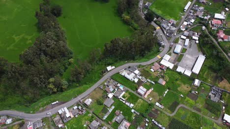 Winding-country-road-boundary-of-Ecuador-rural-village-homesteads-DRONE
