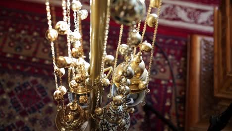 Ornate-censer-hangs-in-church-with-intricate-patterns