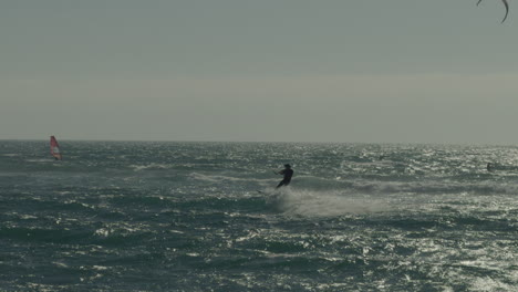 Silhouette-Of-Male-Kite-Surfer-Riding-Wave-Off-Coast-Of-Matanzas,-Chile