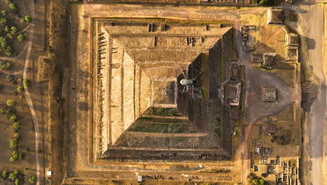 Aerial-top-view-above-a-drone-flying-Teotihuacan-Pyramid,-golden-hour-in-Mexico