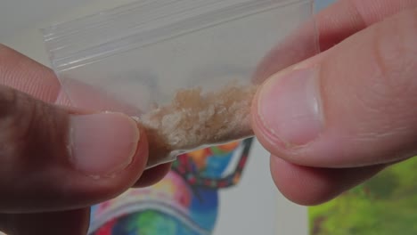 touching-transparent-bag-of-methylenedioxymethamphetamine