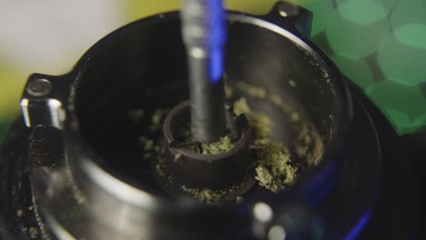 close-up-of-using-a-probe-to-pack-marijuana-into-the-bowl-of-a-vaporizer-used-for-smoking-pot-or-medical-marijuana