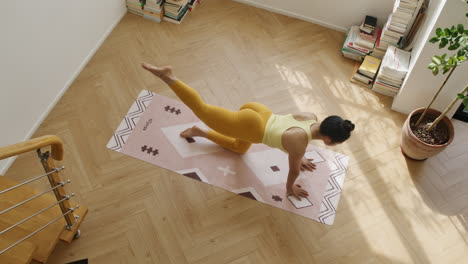Top-down-view-of-asiatic-woman-legs-muscle-stretching-workout-in-modern-apartment-room,-yoga-daily-practise-fitness-young-girl-asiatic-in-yellow-sportswear
