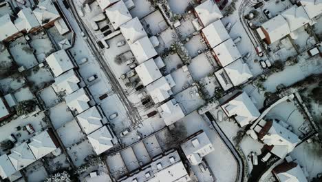 UK-snowy-blast-causes-chaos---aerial-of-residential-area-in-Wirral,-gimbal-down,-snowy-roofs,-Merseyside---Jan-24
