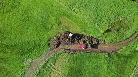 Excavator-At-Work-Digging-Soil-On-Lush-Field-In-Summer