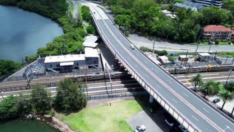 Drone-aerial-pan-landscape-train-on-tracks-train-line-railway-Gosford-station-waterfront-infrastructure-travel-transport-Brian-McGowan-Bridge-Central-Coast-Australia