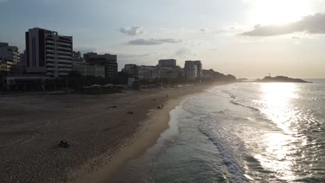 Flying-through-Ipanema,-where-the-waves-finds-the-beach