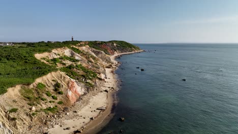 Wide-aerial-shot-of-the-Martha's-Vineyard-shoreline-with-the-Gay-Head-Lighthouse-on-the-horizon