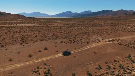Modern-black-car-on-desert-dirt-road-off-road-in-Nevada-close-to-Death-Valley