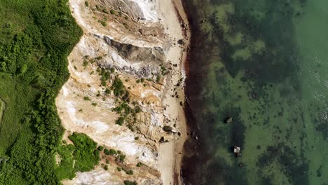 Top-down-drone-shot-of-the-Massachusetts-shoreline-on-a-sunny-day