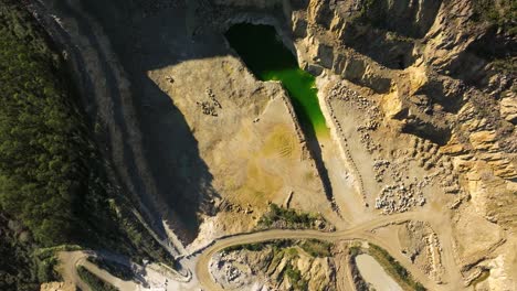 Overhead-View-Of-Open-pit-Mining-With-Groundwater-On-A-Sunny-Day-In-Castriz,-Spain