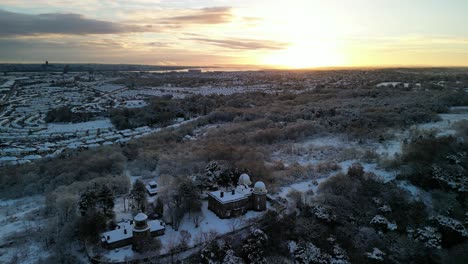 UK-snowy-blast-causes-chaos---view-of-Merseyside-from-Bidston-Hill,-Wirral---aerial-drone-rotate-around-Observatory