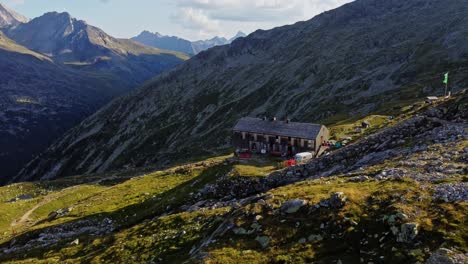 drone-shot-beautiful-scenic-view-of-European-hut-named-"Olpererhütte"-in-Austrian-Alps-in-summer-with-the-Schlegeis-Stausee-below