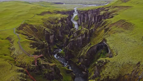 Orbit-drone-shot-of-Fjaðrárgljúfur-a-stunning-canyon-in-Iceland-during-summer-time