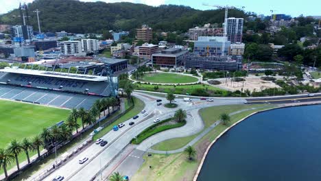Drone-aerial-Mariners-Gosford-stadium-waterfront-cars-traffic-on-roundabout-buildings-CBD-travel-tourism-Central-Coast-Australia
