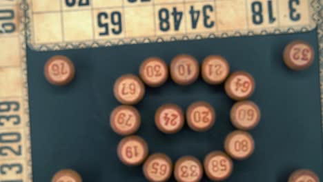Creative-close-up-smooth-zoom-in-shot-from-above-of-a-Bingo-wooden-barrels-in-a-circle,-woody-figures,-old-numbers-background,-vintage-board-game,-professional-lighting,-slow-motion-4K-video