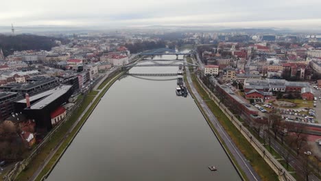Vistula-river-and-Krakow-city-waterfront-aerial-panorama,-modern-and-historic-architecture
