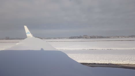 Snow-covered-Wing-Of-Passenger-Airplane-On-Snowy-Taxiway-Of-Munich-Airport-In-Germany