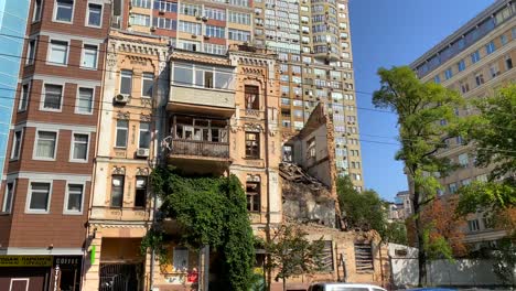 Absolutely-destroyed-and-demolished-civilian-building-by-a-big-rocket-in-Kyiv-Ukraine,-critical-war-damage-in-the-city-capital,-Russia-attacks-Ukraine,-half-of-a-house-missing,-4K-shot