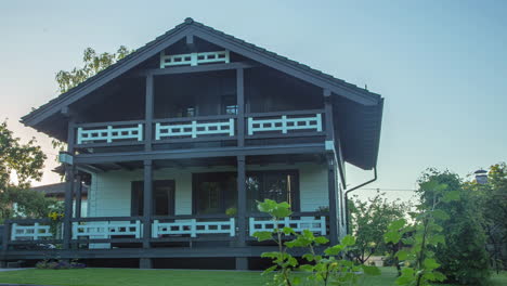Traditional-Austrian-Alpine-style-chalet-house,-during-sunrise---pull-back-shot
