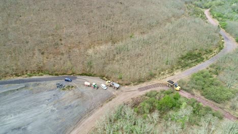 Heavy-duty-truck-loaded-with-soil-on-a-track,-aerial-view
