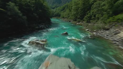 Turquoise-Blue-Rough-Water-Of-Soca-River-Flowing-Through-The-Mountain-In-Slovenia,-Italy