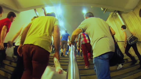Endless-stream-of-people-walking-up-stairs-in-station-fisheye-pov