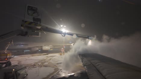 Airplane-Wing-Being-Deiced-At-Munich-Airport-At-Night-In-Germany