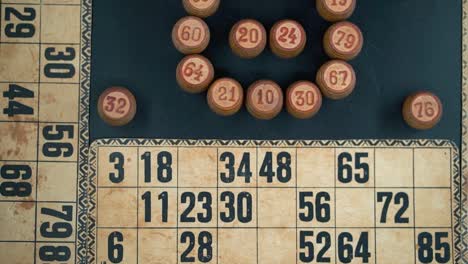 Cinematic-close-up-smooth-tilt-up,-shot-from-above-of-a-Bingo-wooden-barrels,-woody-figures,-old-numbers-background,-vintage-board-game,-lucky-number,-professional-lighting,-slow-motion-120-fps